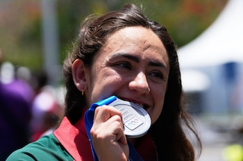 La mexicana Sara Roel muerde su medalla de plata en la contrarreloj individual femenina de los Juegos Centroamericanos y del Caribe. (AP Foto/Fernando Vergara)