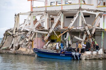 People look at a damaged