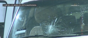 Vista cercana de un parabrisas de coche con una gran grieta en forma de estrella y múltiples fracturas que se extienden desde el centro