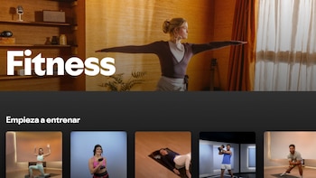 Pantalla de una aplicación de fitness mostrando a una mujer en postura de yoga, junto a miniaturas de personas realizando diferentes ejercicios