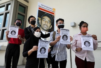 FILE PHOTO: Activists hold posters