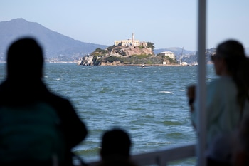 Tourists take photos from a