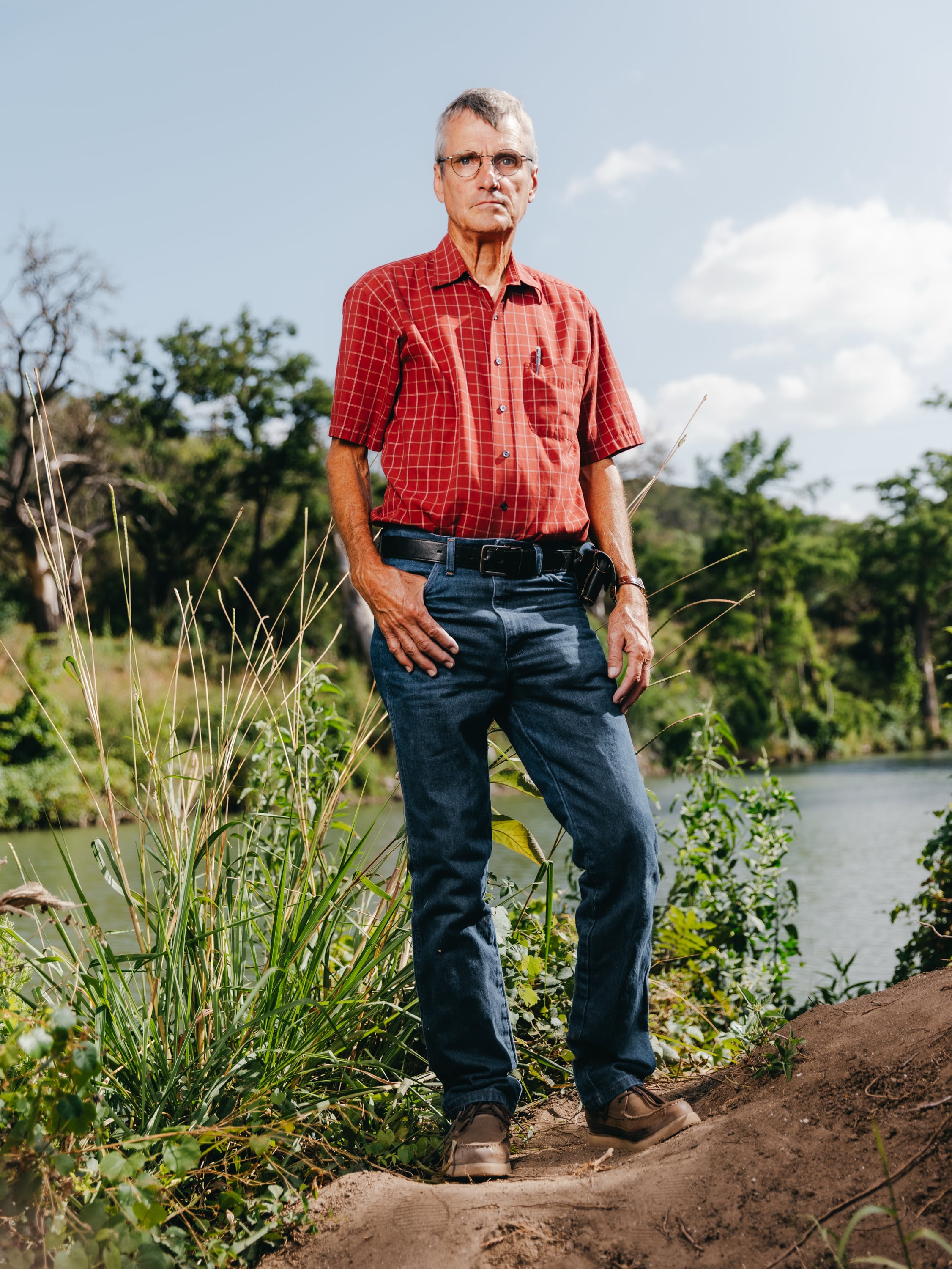 Mike Little, quien rescató a siete personas de las inundaciones hace un año, se encuentra a orillas del río Guadalupe, cerca de su casa (Christopher Lee/The Washington Post)