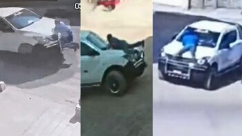 Una persona sobre la capota de una camioneta.