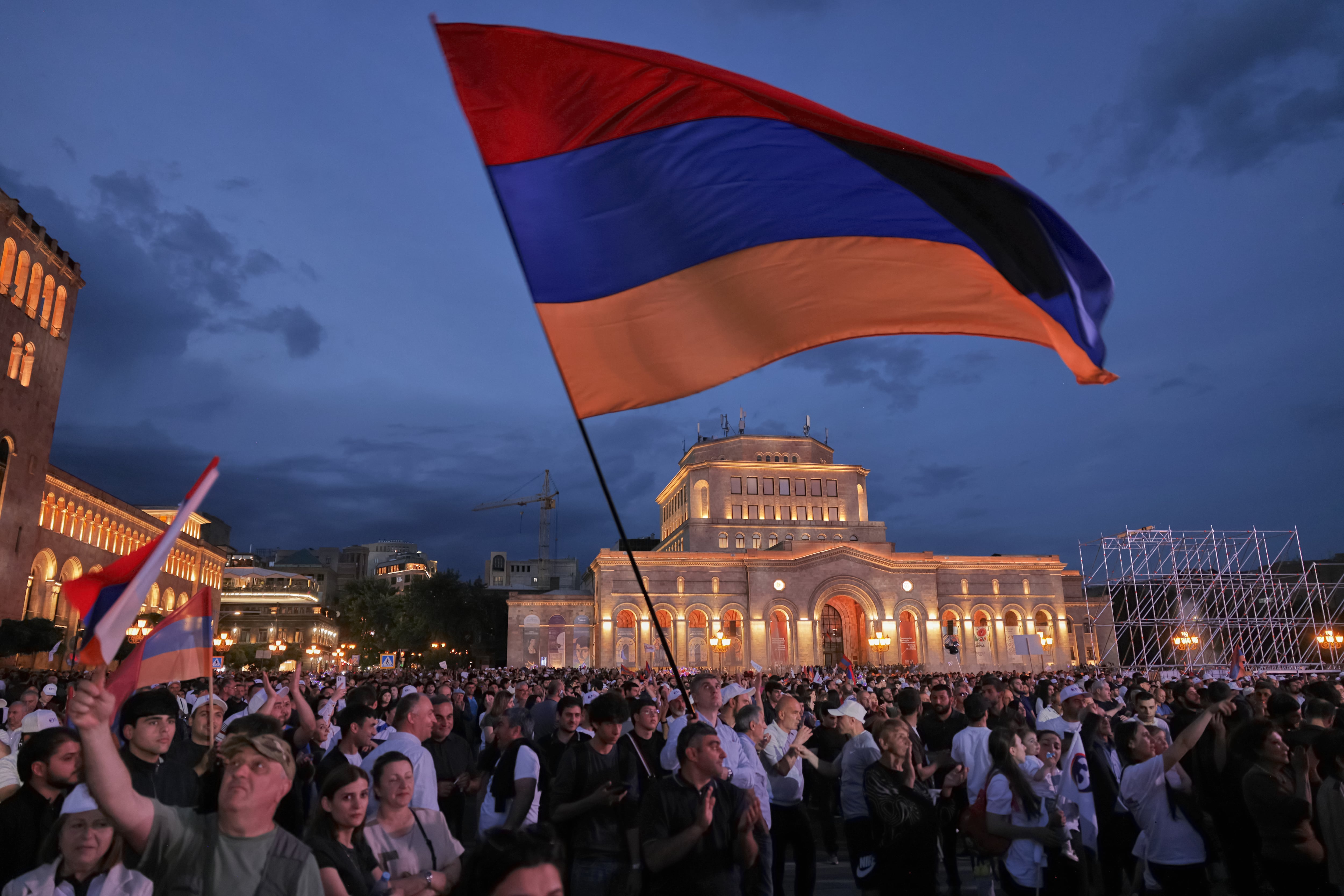 Partidarios del magnate ruso-armenio Samvel Karapetyan ondean una bandera nacional durante una protesta contra el primer ministro en funciones, Nikol Pashinyan, en la Plaza de la República de Ereván, Armenia, el miércoles 3 de junio de 2026. Karapetyan, líder del partido Armenia Fuerte, enfrenta cargos penales que él rechaza por considerarlos políticamente motivados y realiza campaña desde su arresto domiciliario (AP/Anthony Pizzoferrato)