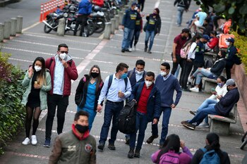 People wearing face masks walk