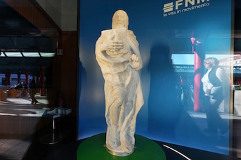 People walk near the "Bearded