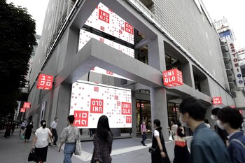 Pedestrians walk past the Uniqlo