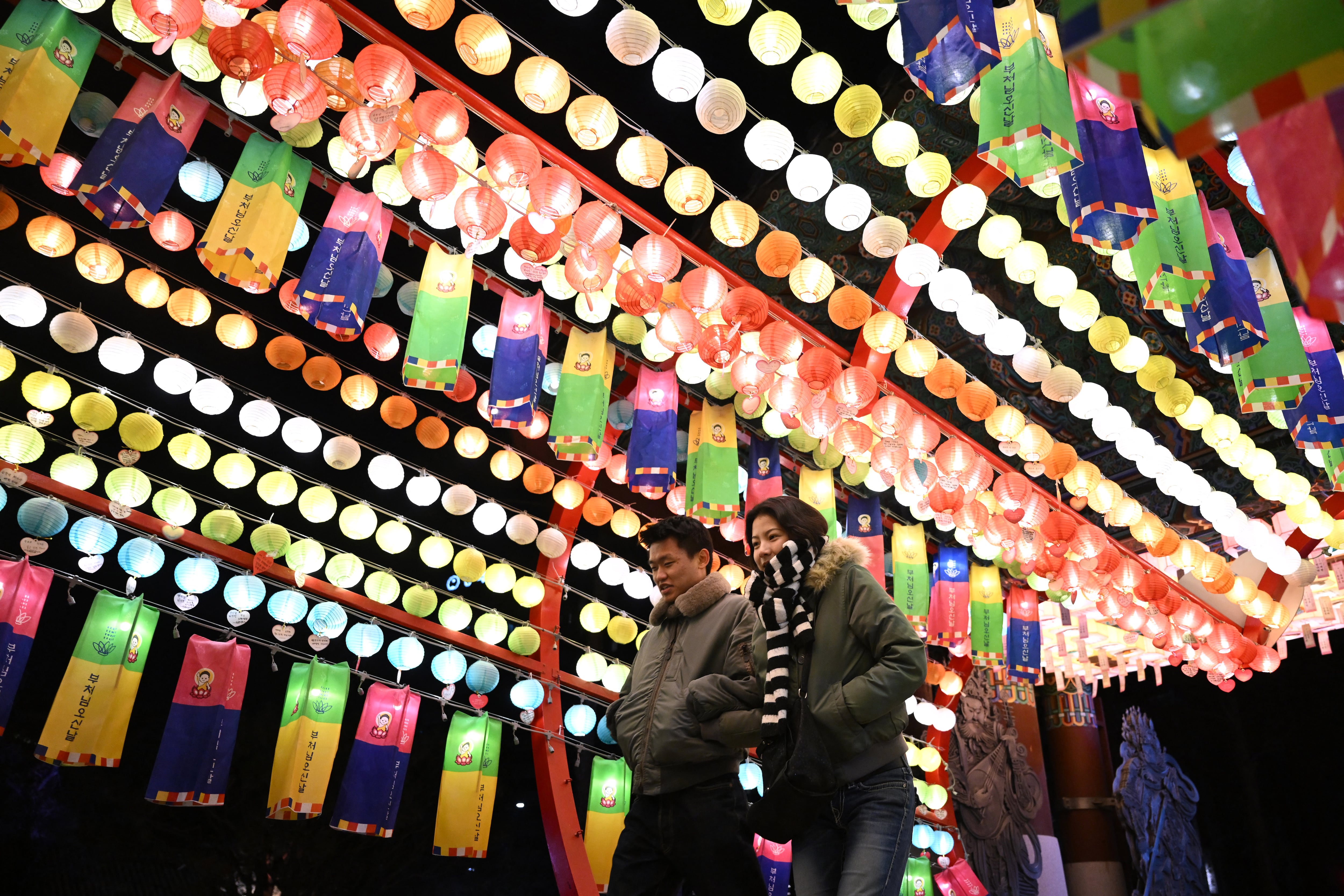 Visitantes caminan bajo linternas con deseos de Año Nuevo de seguidores budistas en el templo Jogyesa en el centro de Seúl. Seúl, 31 de diciembre de 2025. (Foto: Jung Yeon-je / AFP)