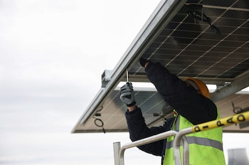 A worker installs a bifacial