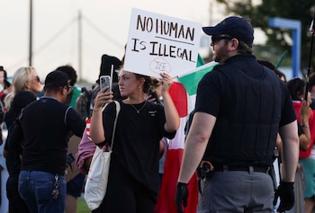 A demonstrator holds a sign