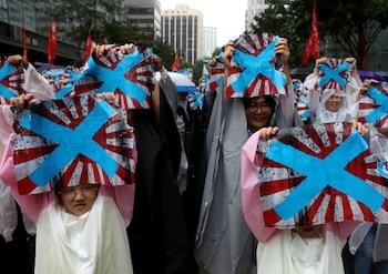 SEOUL, SOUTH KOREA - AUGUST 15: South Koreans hold Japanese rising sun flags during a rally to mark the 74th National Liberation Day in front of Japanese embassy on August 15, 2019 in Seoul, South Korea. South Korea marked its 74th National Liberation Day, which celebrates its independence from Japanese colonial rule following the end of World War II after Japan surrendered between August 14 and 15 in 1945. (Photo by Chung Sung-Jun/Getty Images)
