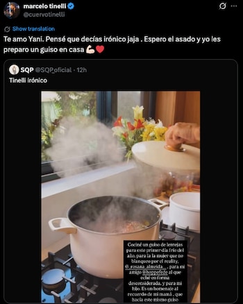 Una olla grande con vapor sobre una estufa de gas, con una mano levantando la tapa; flores decorativas en el fondo borroso
