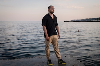 **EMBARGO: No electronic distribution, Web posting or street sales before THURSDAY, 12:01 A.M. ET, AUG. 13, 2026. No exceptions for any reasons. EMBARGO set by source.** Blesson Sebastian stands in the port city of Odesa, Ukraine, Aug. 5, 2026. Sebastian was a second officer on the Golden Leo, a cargo ship that was struck by Russian missiles shortly after departing Odesa on July 19, 2026. He suffered first-degree burns in the attack. (Nicole Tung/The New York Times)