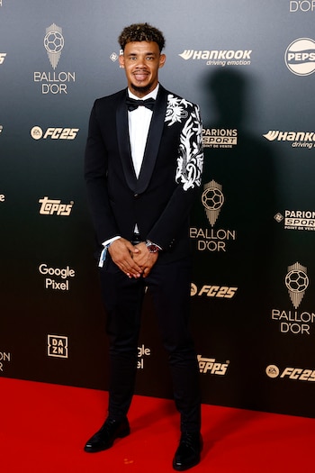 Ronwen Williams optó por un diseño único en su chaqueta: sobre el hombro y parte de la manga hay un elaborado patrón floral en blanco que contrasta con el resto del traje, agregando un toque de creatividad y estilo moderno a su atuendo formal. (REUTERS/Sarah Meyssonnier)