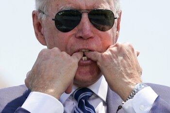 U.S. President Joe Biden whistles in honour of the cadets graduating during the U.S. Coast Guard Academy commencement ceremony in New London, Connecticut, U.S., May 19, 2021. REUTERS/Kevin Lamarque TPX IMAGES OF THE DAY