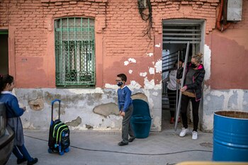 Residents moving out of the building famously photographed by Robert Capa in the Vallecas neighborhood of Madrid on March 15, 2021. The bomb-scarred building in Capa's picture of children during the war is to be turned into a cultural center. (Maria Contreras Coll/The New York Times)