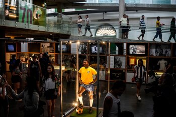 Una estatua de Pelé con el jersey amarillo de la selección brasileña y el número 10 estampado en la espalda es exhibida en una vitrina de vidrio en el Museo Pelé en la ciudad de Santos, Brasil, el viernes 30 de diciembre de 2022. (AP Foto/Matias Delacroix)