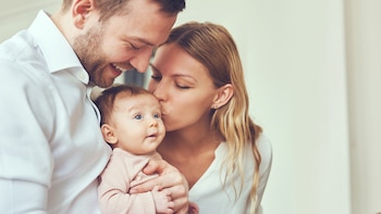 Smiling mother and father holding