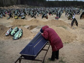 A woman reacts during a funeral of her relative, who died during the shelling by Russian troops, amid Russia's invasion of Ukraine, at the cemetery in Irpin, Kyiv region, Ukraine April 17, 2022. REUTERS/Gleb Garanich TPX IMAGES OF THE DAY