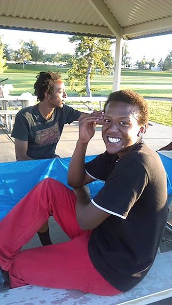 Elijah McClain, an unarmed Black man who died days after he was subdued by three policemen and injected with a powerful sedative in August 2019, is seen with a family member in an undated photograph in Aurora, Colorado, U.S. Family photo/Handout via REUTERS. NO RESALES. NO ARCHIVES. THIS IMAGE HAS BEEN SUPPLIED BY A THIRD PARTY.