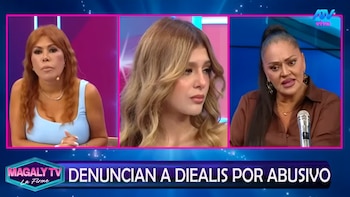 Tres mujeres en un panel de televisión: Magaly Medina en azul, una joven rubia en el centro, y otra mujer morena con micrófono. Banner: 'DENUNCIAN A DIEALIS POR ABUSIVO'