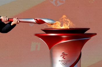 Olympics - Beijing 2022 Winter Olympics - Torch Relay - Beijing, China - February 2, 2022. Chinese Vice Premier Han Zheng lights an Olympic torch from the cauldron during the launching ceremony at the Olympic Forest Park. REUTERS/Florence Lo TPX IMAGES OF THE DAY