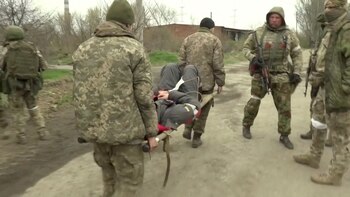 Soldiers carry a wounded man on a stretcher in a location given as Mariupol, Ukraine, in this still image taken from video that Russian TV released April 13, 2022, and says shows Ukrainian marines surrendering in Mariupol. Reuters could not independently confirm the surrender and authenticity of the Russian TV footage. RURTR/via Reuters TV/Handout via REUTERS ATTENTION EDITORS - THIS IMAGE HAS BEEN SUPPLIED BY A THIRD PARTY. NO RESALES. NO ARCHIVES. RUSSIA OUT. NO COMMERCIAL OR EDITORIAL SALES IN RUSSIA