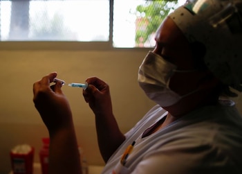 A medical worker fills a