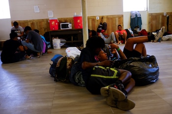 Migrants rest at the Opportunity