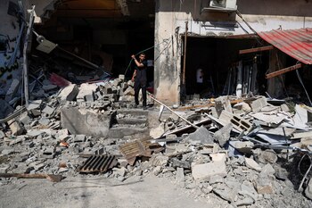 Un palestino inspecciona los daños