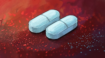 Dos pastillas alargadas celestes con una línea central, sobre un fondo abstracto de tonos rojizos y puntos dispersos rojos y azules.