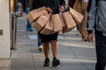 A pedestrian carries Nespresso shopping