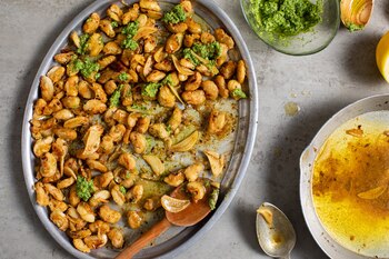 Brown-butter butter beans with lemon and pesto, in New York, Feb. 6, 2021. These butter beans with lemon and pesto sing under a healthy dose of caramelized, nutty butter. (Andrew Scrivani/The New York Times)
