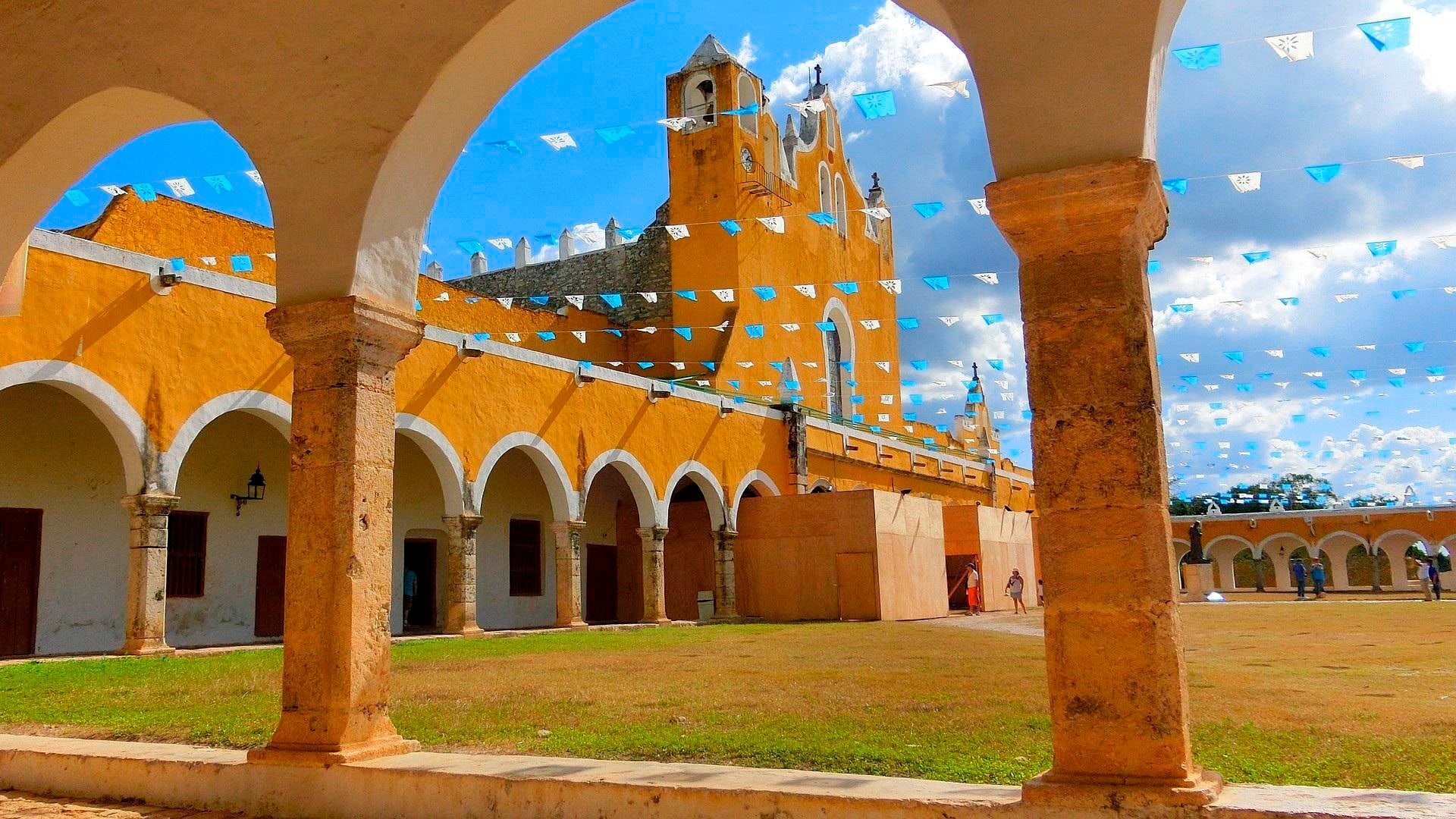 El convento de San Antonio de Padua en Izamal muestra sus arcos amarillos y su atrio decorado con banderines en el estado de Yucatán, México (Pixabay)