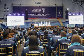 Auditório com público uniformizado ao fundo