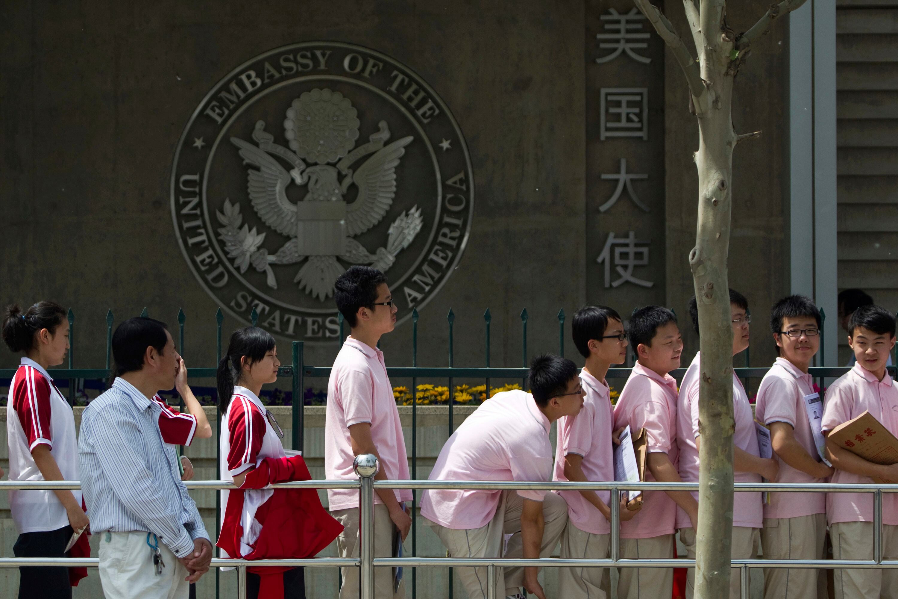 Estudiantes chinos aguardan afuera de la embajada de Estados Unidos para sus entrevistas de solicitud de visa, en Beijing (AP Foto/Alexander F. Yuan, archivo)