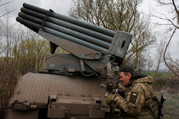 A Ukrainian serviceman works with