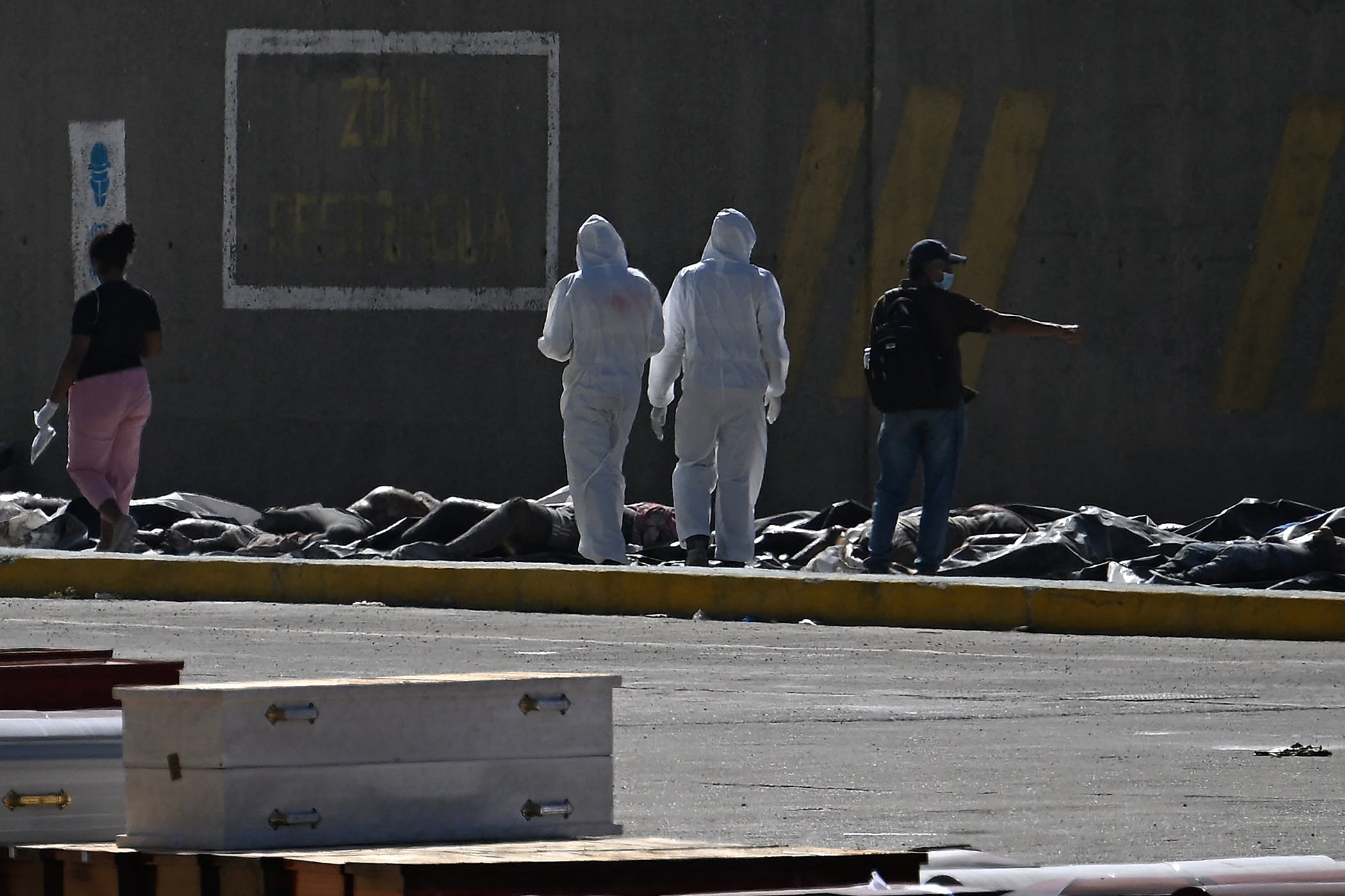 Peritos forenses trabajan en la identificación de víctimas en una morgue improvisada instalada en el puerto de La Guaira, una de las zonas más afectadas por los terremotos en Venezuela (Federico Parra / AFP)