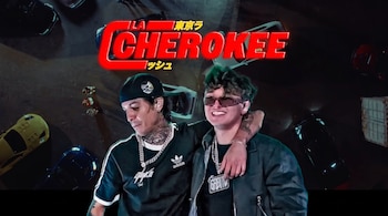 Dos hombres con gorras y cadenas posan delante de un logotipo rojo que dice La Cherokee Tokyo Rush y coches deportivos en un fondo oscuro.