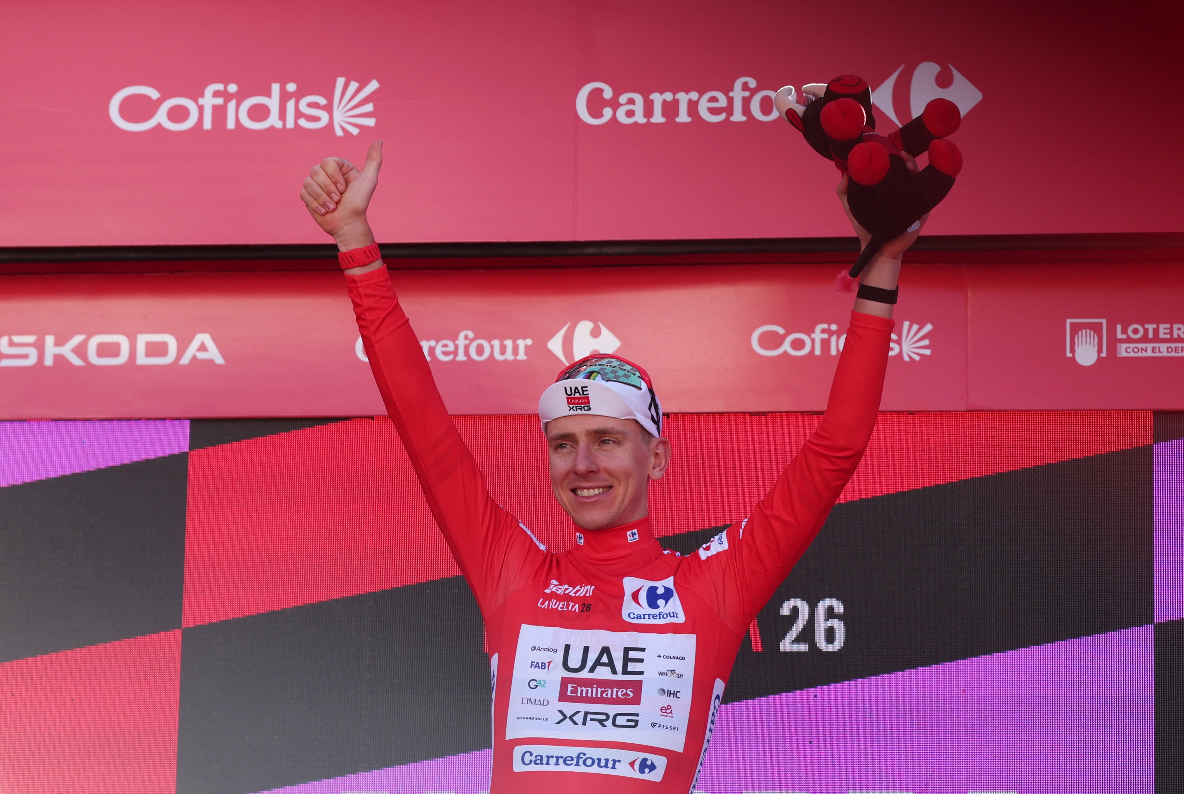 Cycling - Vuelta a Espana - Stage 4 - Andorra la Vella to Andorra la Vella - Andorra la Vella, Andorra - August 25, 2026 UAE Team Emirates - XRG's Tadej Pogacar celebrates wearing the red jersey on the podium after stage 4 REUTERS/Bruna Casas
