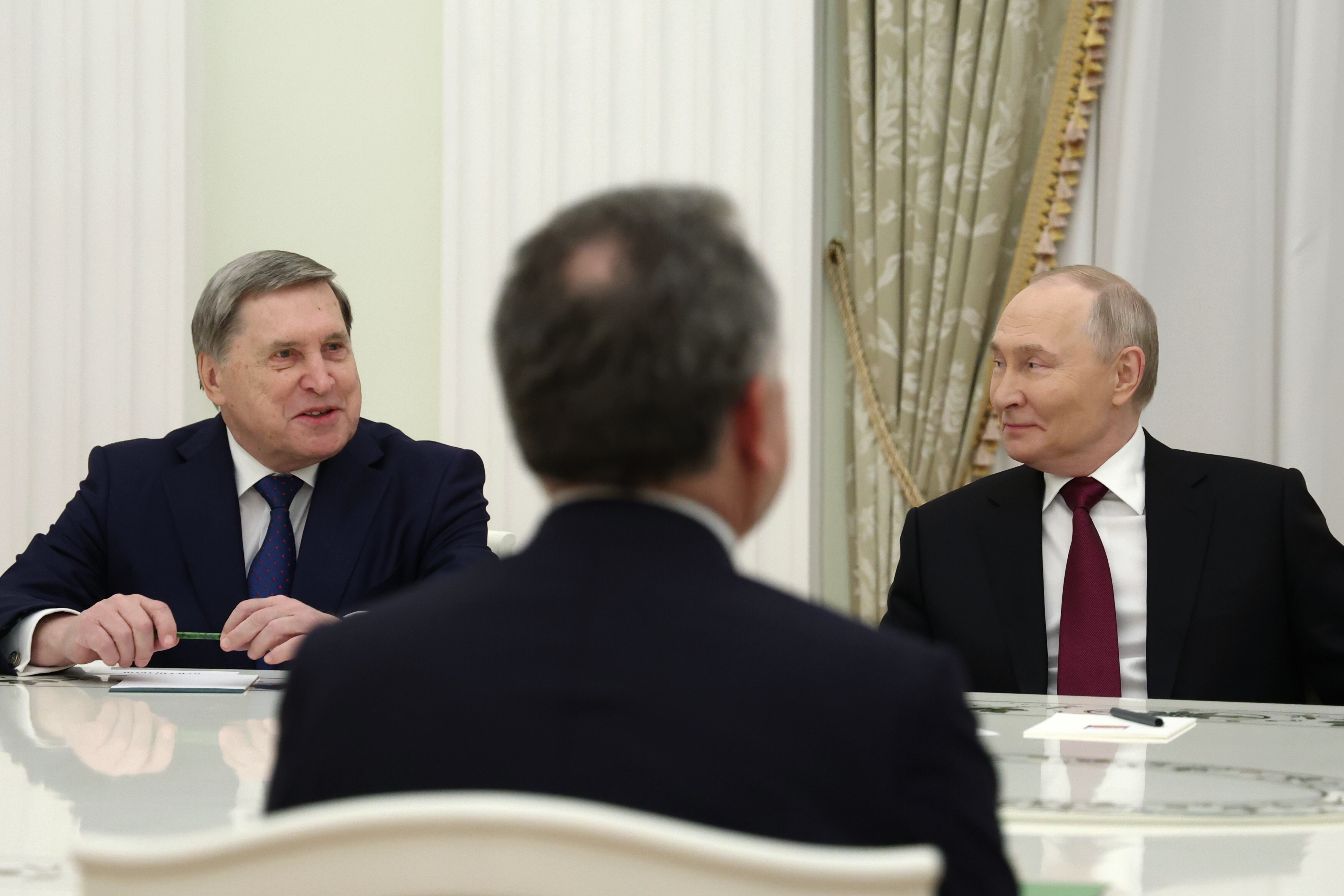 El presidente de Rusia, Vladímir Putin, a la derecha y el asesor presidencial ruso de política exterior, Yuri Ushakov, a la izquierda, asisten a una reunión con el enviado especial de Estados Unidos Steve Witkoff, de espaldas a la cámara, en el Palacio del Senado del Kremlin, en Moscú, Rusia, el martes 2 de diciembre de 2025. (Alexander Kazakov, Sputnik, pool del Kremlin via AP)
