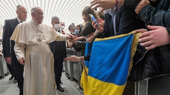 Pope Francis greets people who