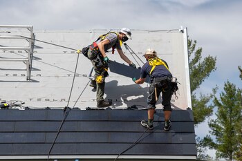 A crew installs Tesla solar
