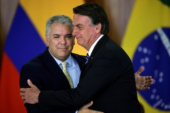 Colombia's President Ivan Duque greets