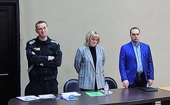 Russian opposition leader Alexei Navalny, accused of fraud and contempt of court, his lawyers Olga Mikhailova and Vadim Kobzev are seen on a screen via a video link during a court hearing at the IK-2 corrective penal colony in the town of Pokrov in Vladimir Region, Russia March 22, 2022. Navalny is already serving a two-and-a-half year sentence at a prison camp east of Moscow for parole violations. REUTERS/Evgenia Novozhenina