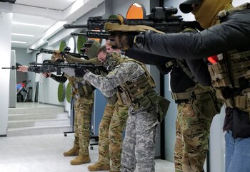 Men, who volunteer for territorial defense take part in a training with weapons at a private company room following the Russia's invasion of Ukraine, in Lviv, Ukraine, March 23, 2022. REUTERS/Zohra Bensemra