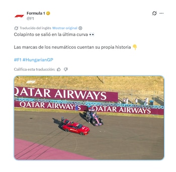 Coche de seguridad rojo y monoplaza de Fórmula 1 rosa en una pista, con marcas de neumáticos y banners de Qatar Airways. Varias personas observan
