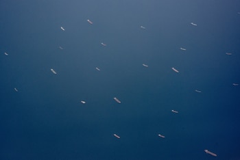 FILE — Ships near the Strait of Hormuz, as seen from a plane near the United Arab Emirates, July 20, 2026. Iran has survived decades of sanctions. Faced with more, it is likely to escalate rather than surrender, analysts said. (Tomas Munita/The New York Times)