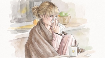 Ilustración en acuarela de una mujer rubia cubierta con una manta marrón que se limpia la nariz con un pañuelo junto a una taza de té.